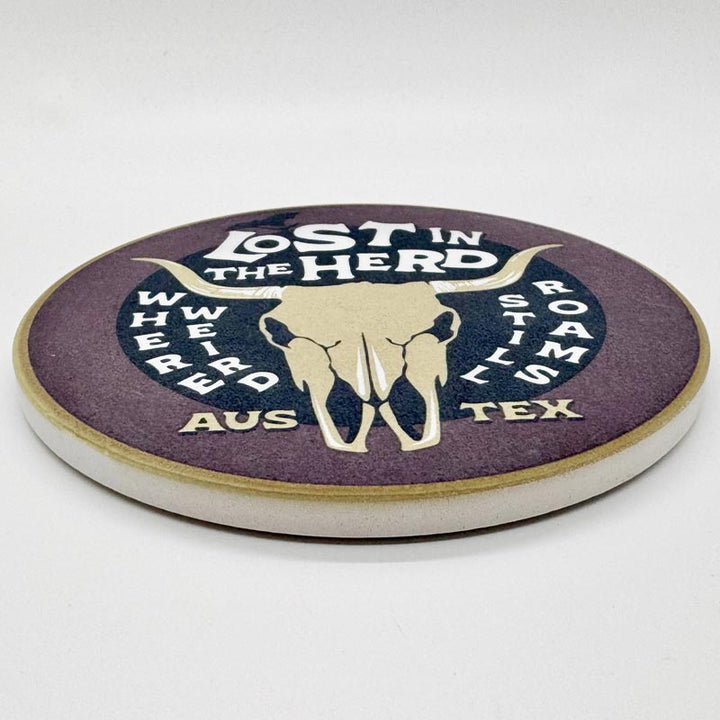 Round coaster with 'Lost in the Herd' design on a white background