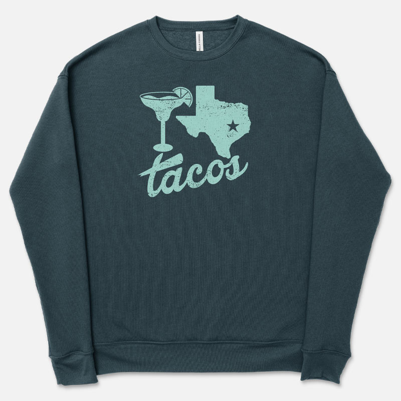 A green sweatshirt with a graphic of Texas and a taco on it, along with the text 'TACOS'.