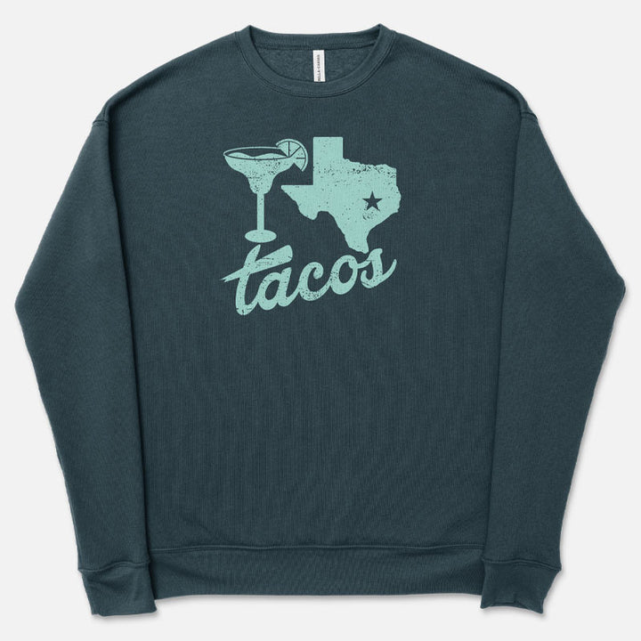 A green sweatshirt with a graphic of Texas and a taco on it, along with the text 'TACOS'.