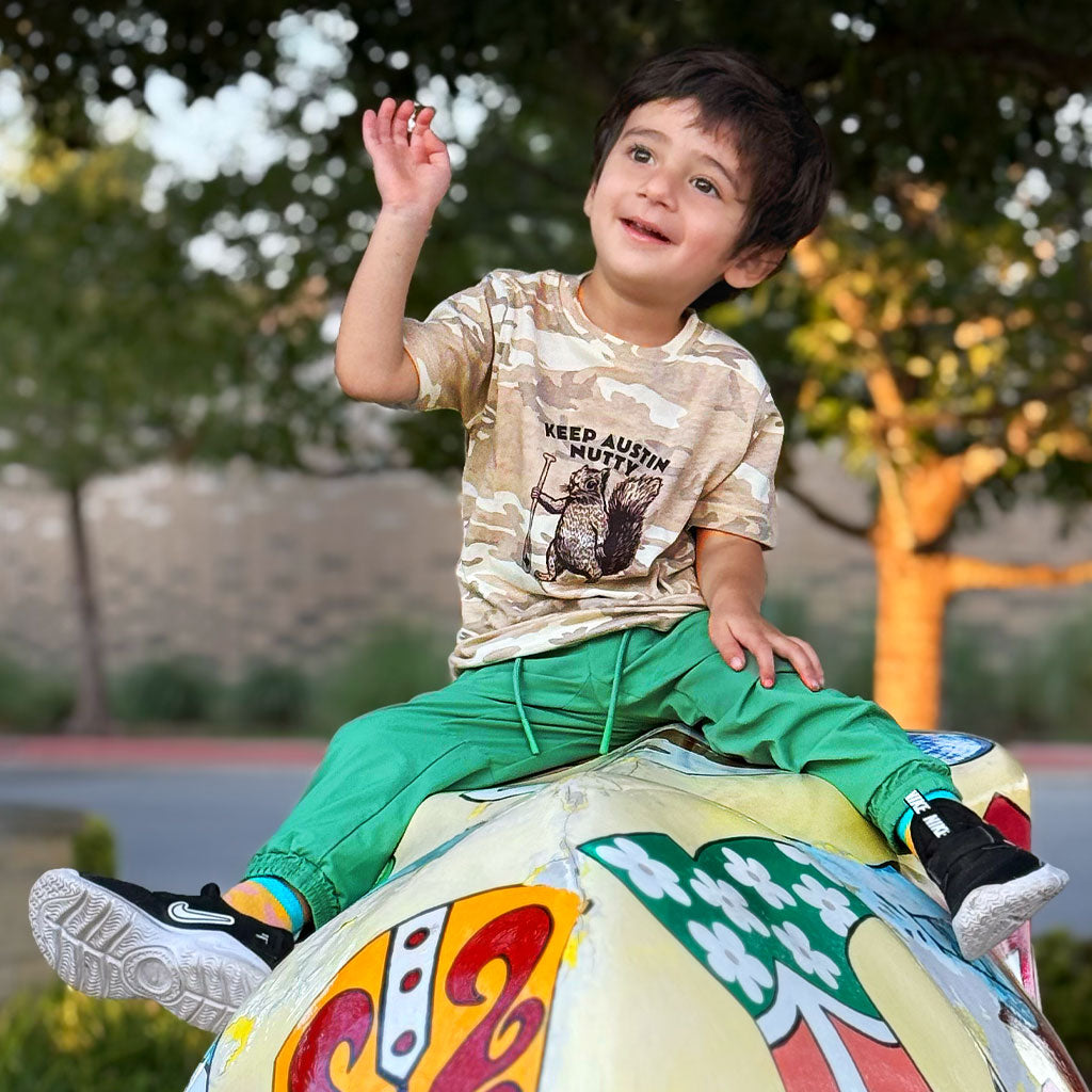 Child riding a colorful inflatable horse toy outdoors