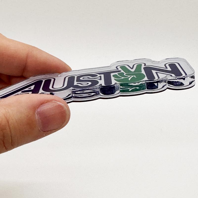 Side view of Peace Austin magnet showing .25-inch thick acrylic layer
