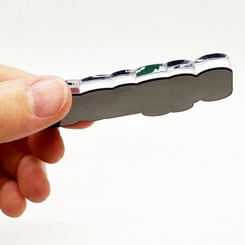 Side view of Peace Austin magnet showing .25-inch thick acrylic layer
