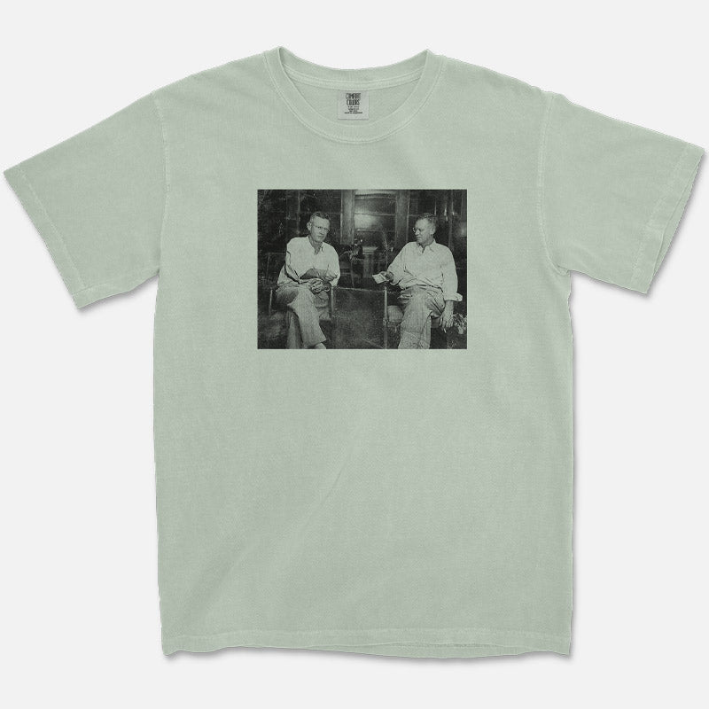 Vintage-style t-shirt with black-and-white photo of man doing a photography trick, titled "Snapshots & Smoke"