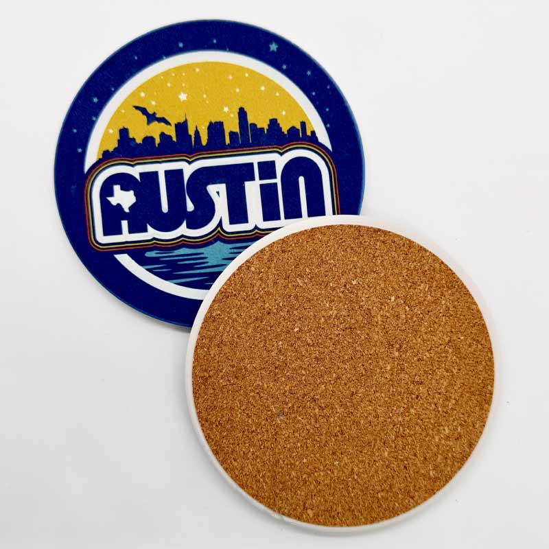 Round coaster with 'Austin' design featuring a city skyline and cork back on a white background
