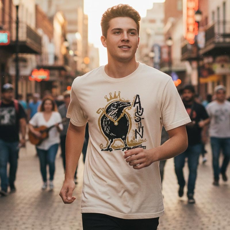 Man wearing a white t-shirt with a graphic design on a city street.