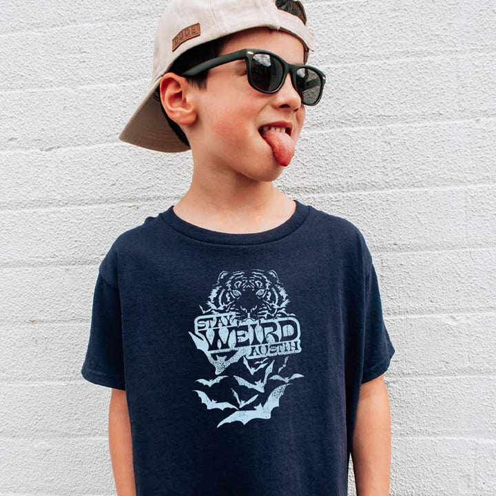 Model wearing our Stay Weird Austin youth t-shirt with bold, playful graphic – fun and quirky ATX tee for kids