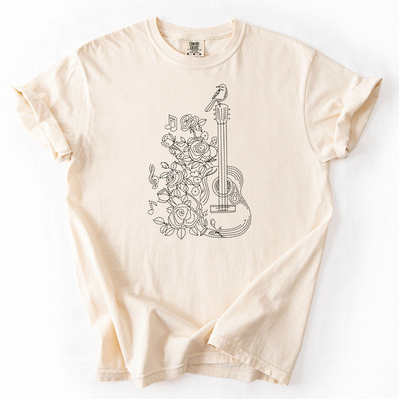 Stitch styled design featuring a guitar, bird and roses on a Comfort Colors 1717 Ivory T-shirt