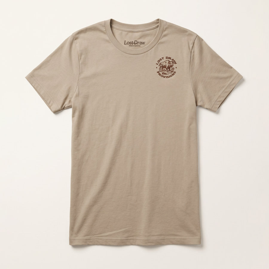 Front of the Tan Face the Storm Jersey Tee featuring a small Lost Draw Provisions buffalo emblem on the left chest.