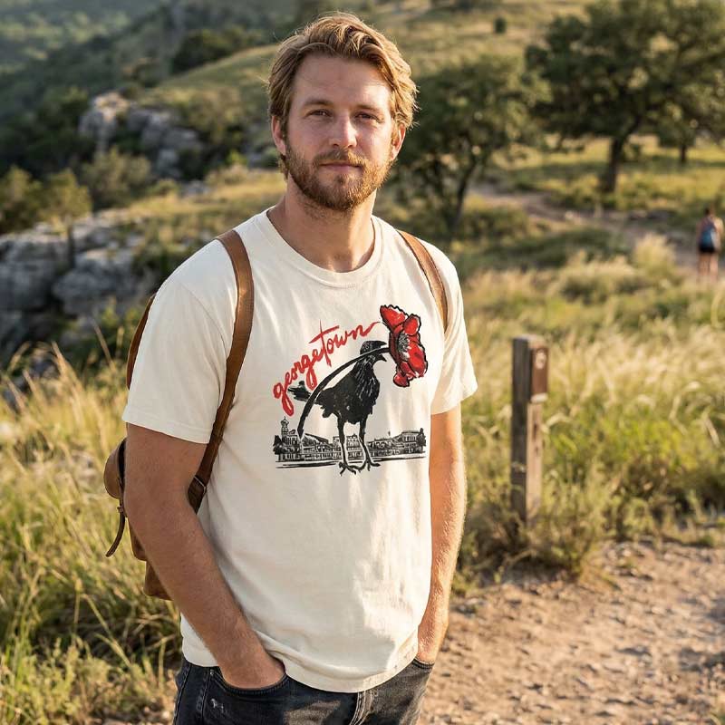 Person wearing Georgetown Texas red poppy grackle shirt near Georgetown Square