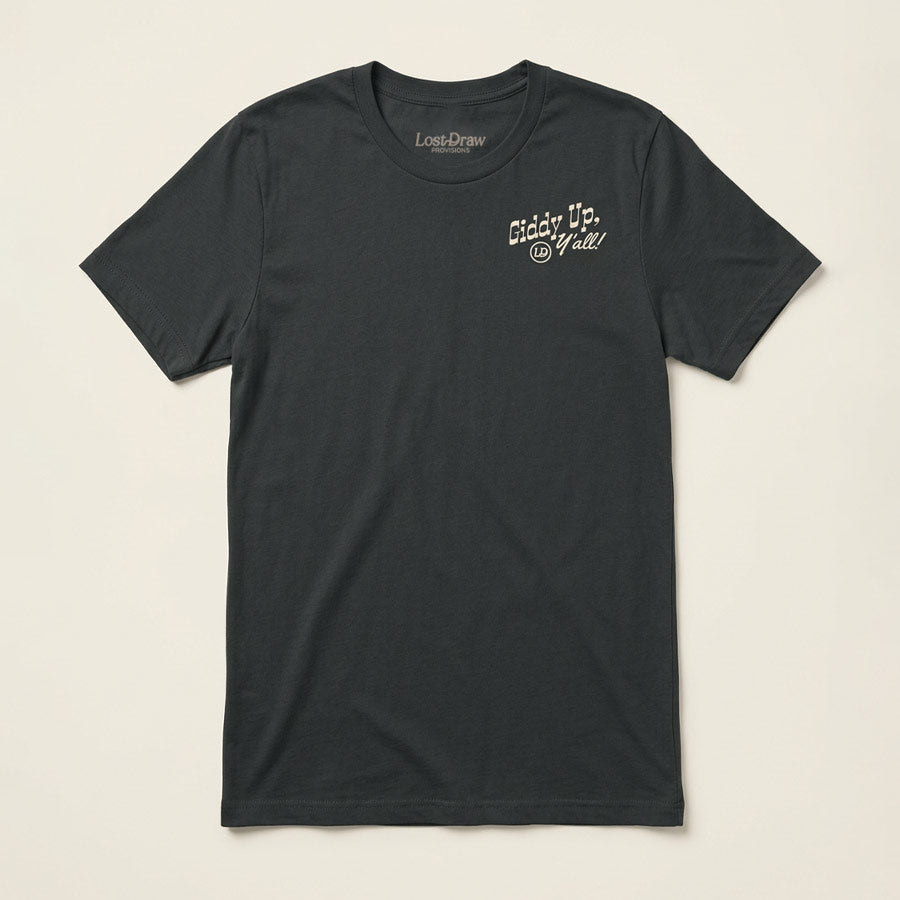 A dark charcoal gray crewneck t-shirt with a small white graphic on the left chest reading &