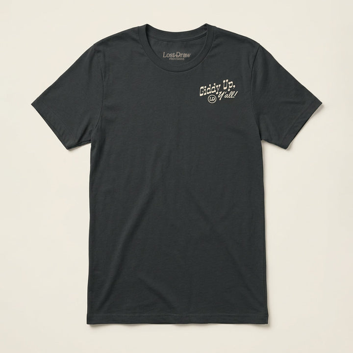 A dark charcoal gray crewneck t-shirt with a small white graphic on the left chest reading &
