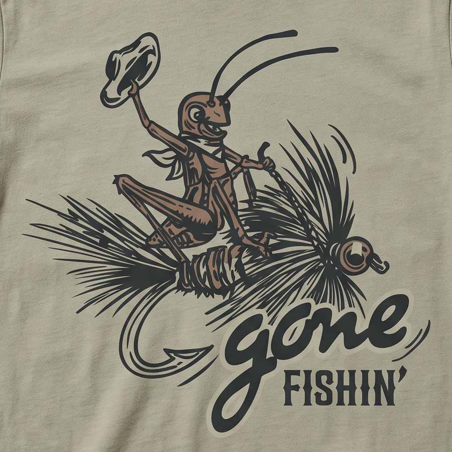 Close-up of a beige graphic print featuring a cartoon grasshopper wearing a hat and riding a fishing hook with the words &