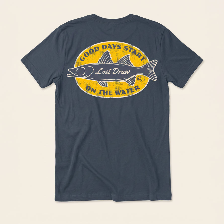 Back of the Vintage Navy On the Water Tee featuring a distressed yellow fishing badge and Good Days Start on the Water lettering.