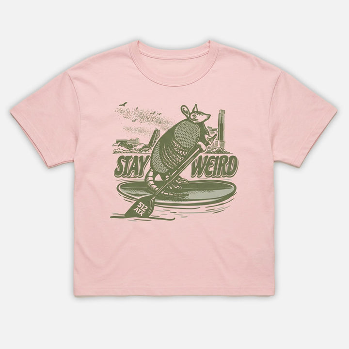 flay lay front view of Stay Weird 512 women’s heavyweight t-shirt in soft pink