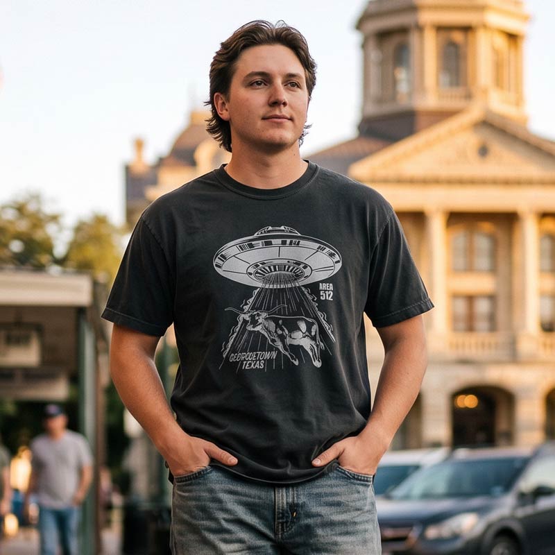 Man wearing the Georgetown Area 512 black Comfort Colors t-shirt while walking near downtown Georgetown, Texas.