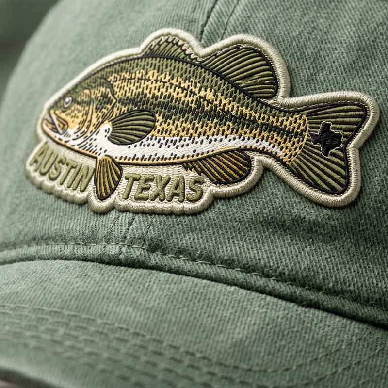 Close-up detail of ATX Bass Hat uv printed embroidered styled bass patch and garment-dyed cotton texture