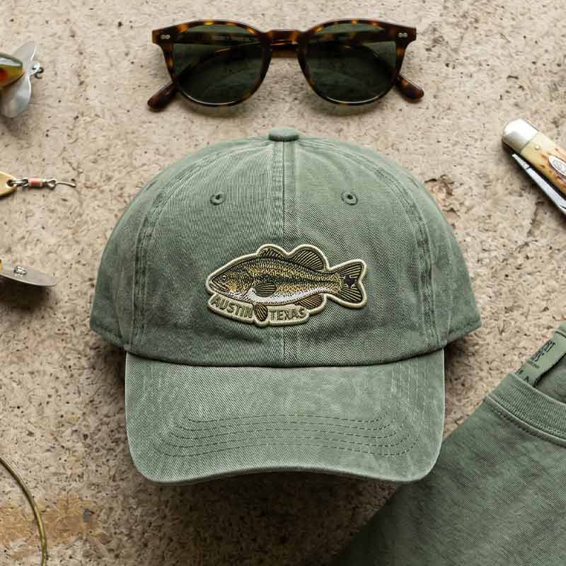 Flat lay of ATX Bass Hat with fishing-inspired outdoor styling
