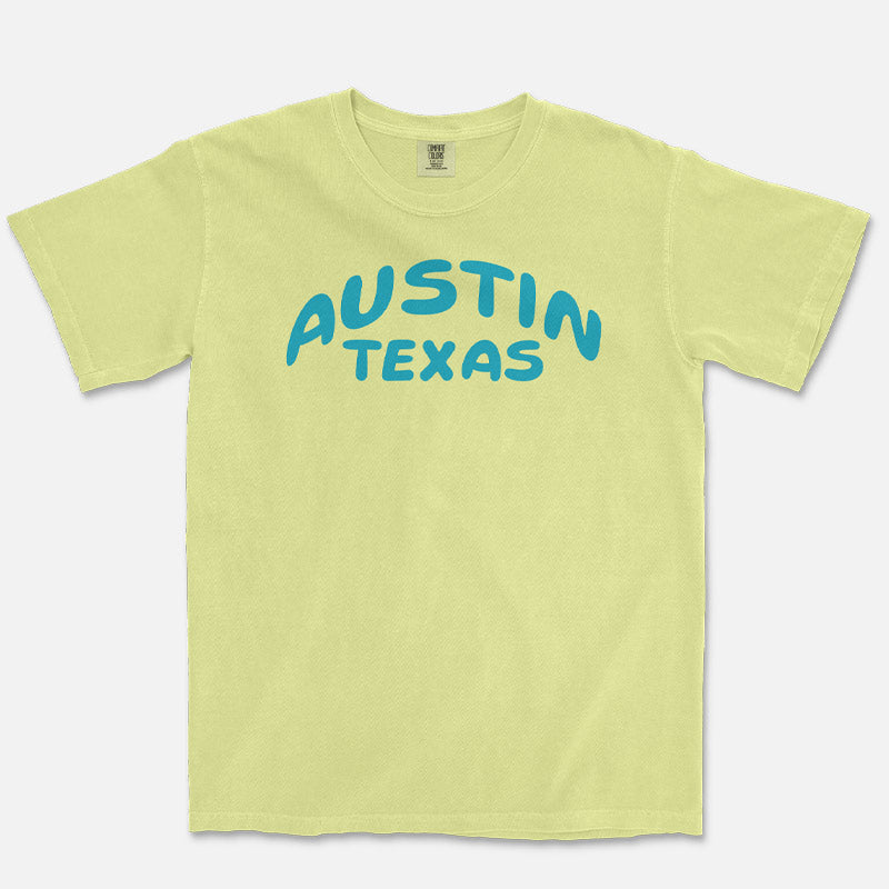 Front view of a Neon Lemon Comfort Colors 1717 heavyweight unisex t-shirt featuring an aqua blue Austin Texas graphic across the chest.