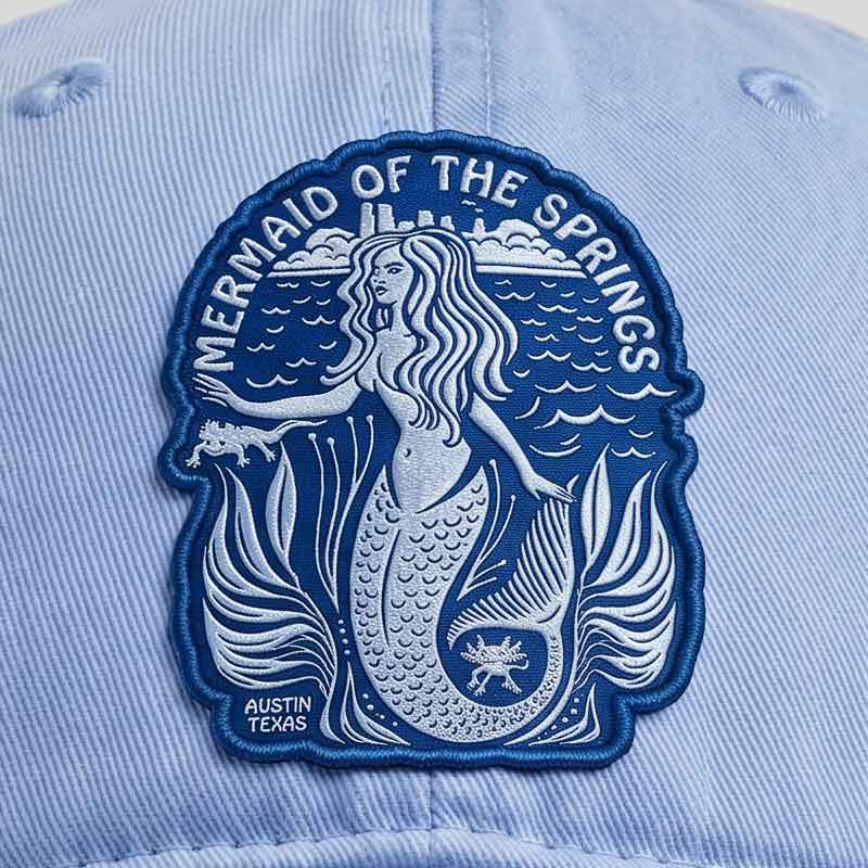 Close-up detail of Barton Springs Mermaid embroidered patch and sunwashed cotton twill texture