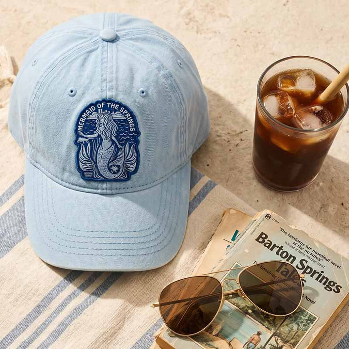 Flat lay of Barton Springs Mermaid Hat with chambray washed fabric and mermaid patch