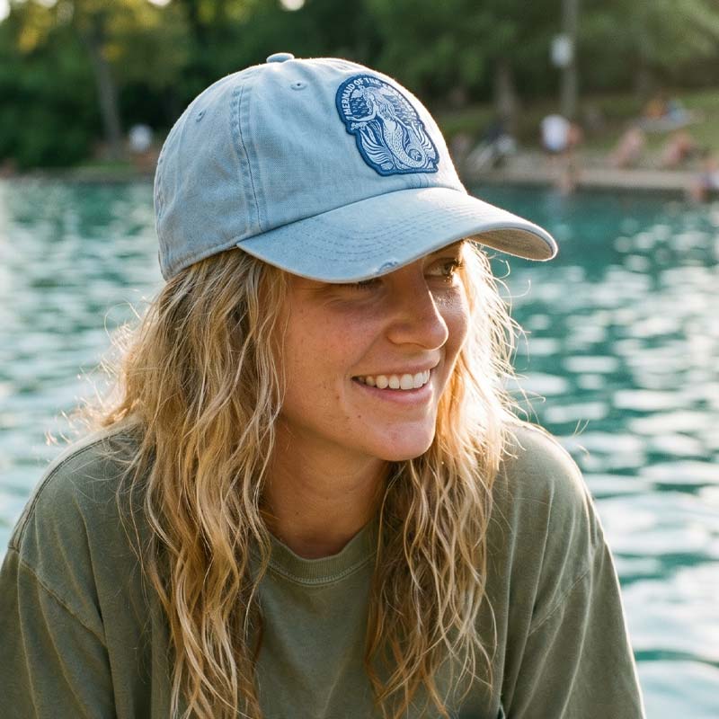 Woman wearing Barton Springs Mermaid Hat outdoors near Barton Springs Pool in Austin