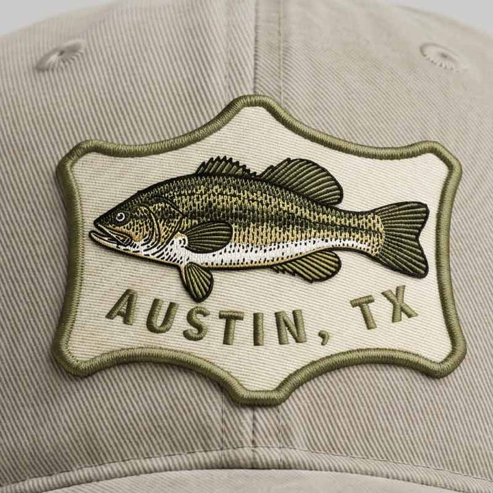 Close-up of Austin Angler Hat bass fish patch and sunwashed cotton twill texture