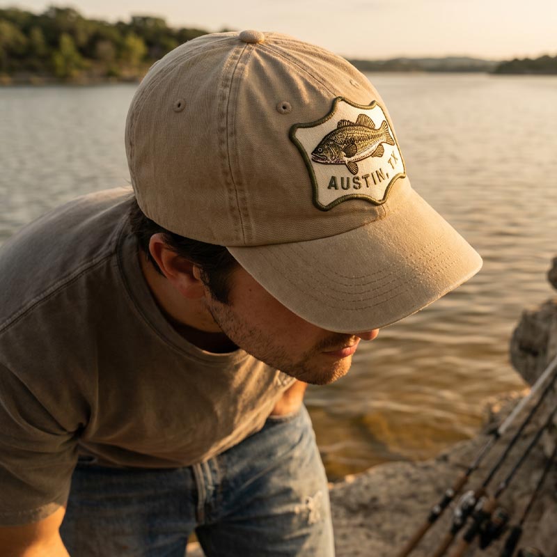 Guy wearing Austin Angler Hat outdoors near a Texas lake