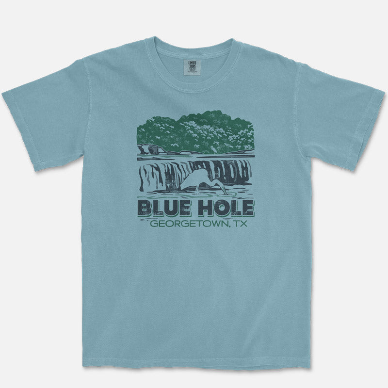 Blue t-shirt with graphic design of Blue Hole, Georgetown, TX on a white background