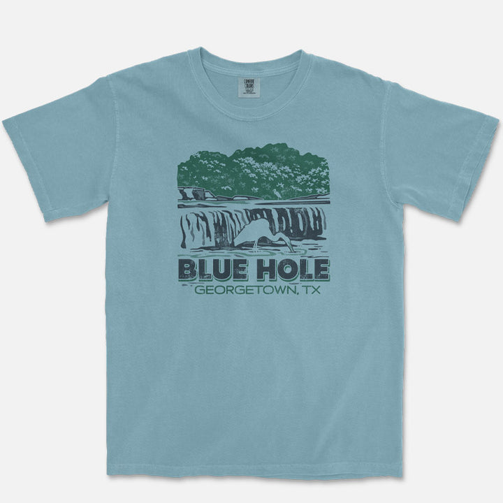Blue t-shirt with graphic design of Blue Hole, Georgetown, TX on a white background