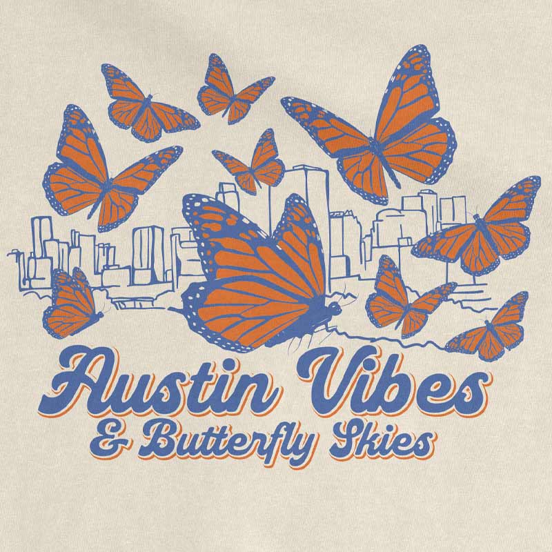 Close-up of butterfly skyline graphic on ivory heavyweight t-shirt