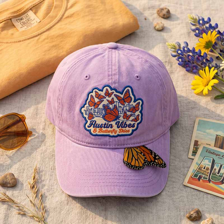 Flat lay of Butterfly Skies Hat with orchid washed fabric and butterfly patch
