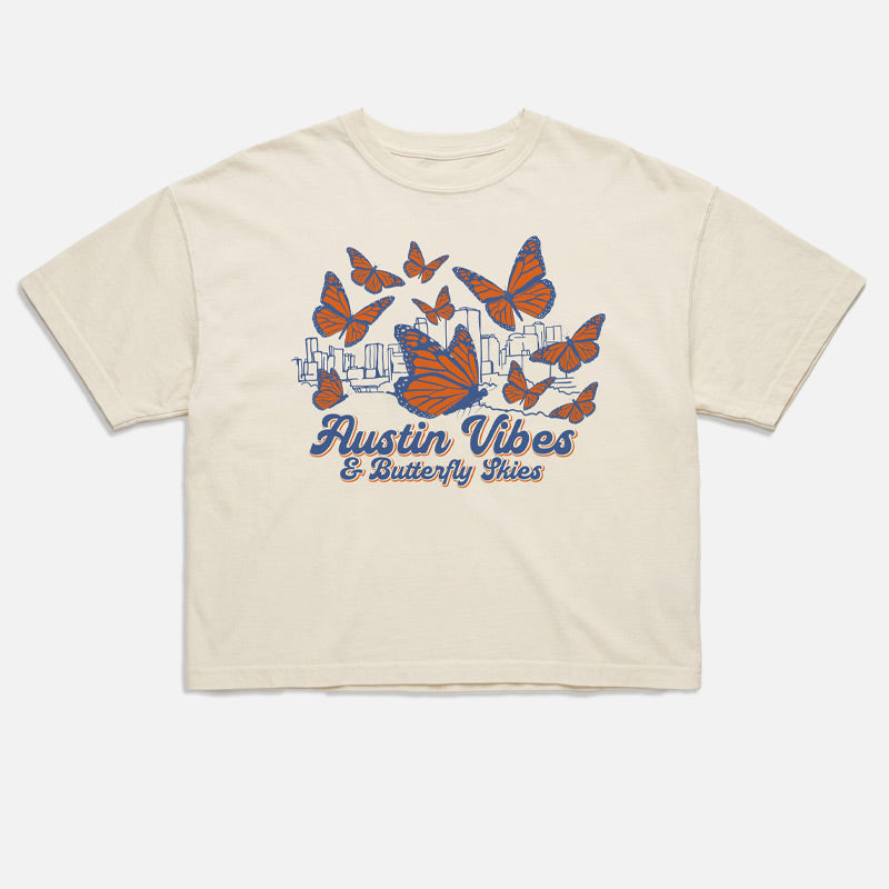 flat lay of Butterfly Skies women’s boxy t-shirt with monarch butterflies and Austin skyline