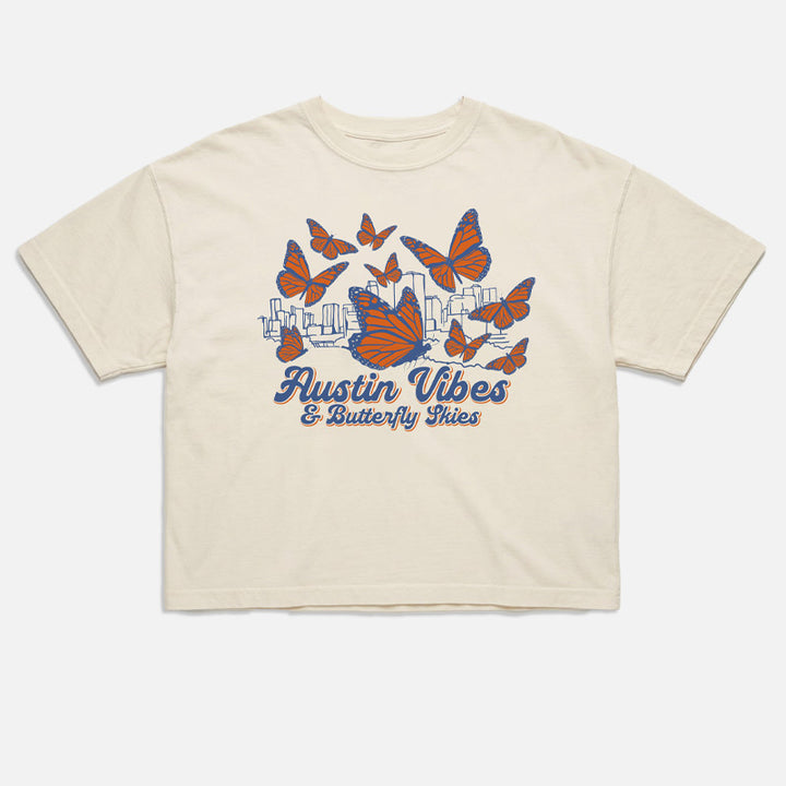 flat lay of Butterfly Skies women’s boxy t-shirt with monarch butterflies and Austin skyline