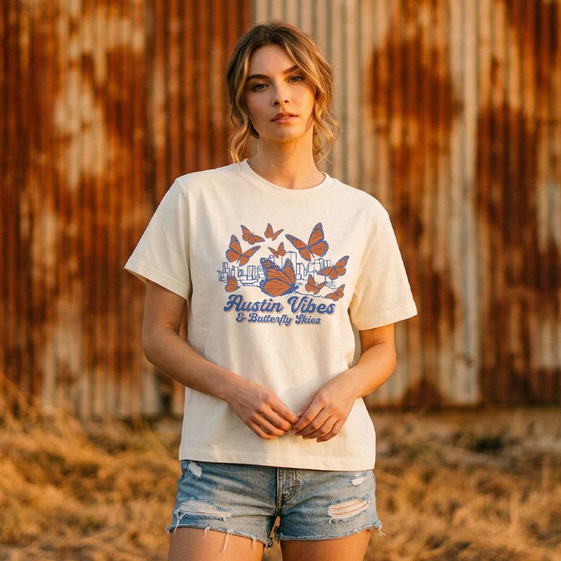 Lifestyle image of woman wearing relaxed fit butterfly graphic tee