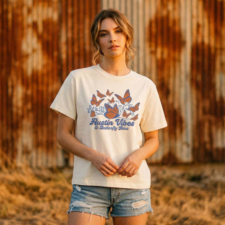Lifestyle image of woman wearing relaxed fit butterfly graphic tee