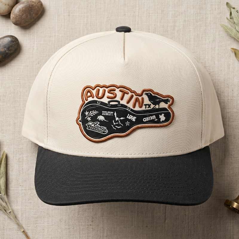Carry-On Austin five-panel hat with cream crown and black curved brim featuring UV printed Austin music-inspired patch