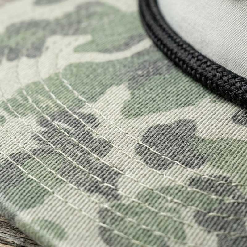 Close-up detail of the Austin guitar case artwork patch on the Carry-On Austin Camo Hat