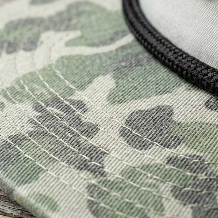Close-up detail of the Austin guitar case artwork patch on the Carry-On Austin Camo Hat
