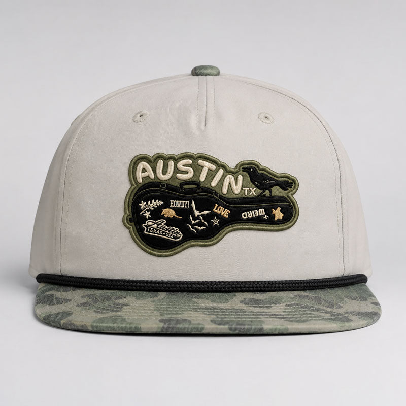 Carry-On Austin Camo Hat featuring Austin guitar case artwork on a London Fog and Duckland camo rope hat