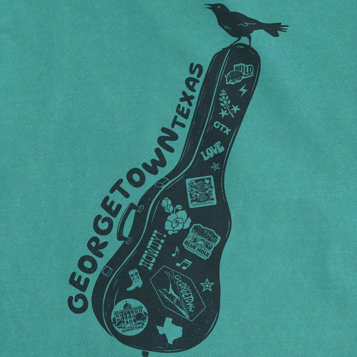 Close up of Carry-On Georgetown Texas T-shirt on seafoam Comfort Colors tee with guitar case graphic and local Georgetown icons