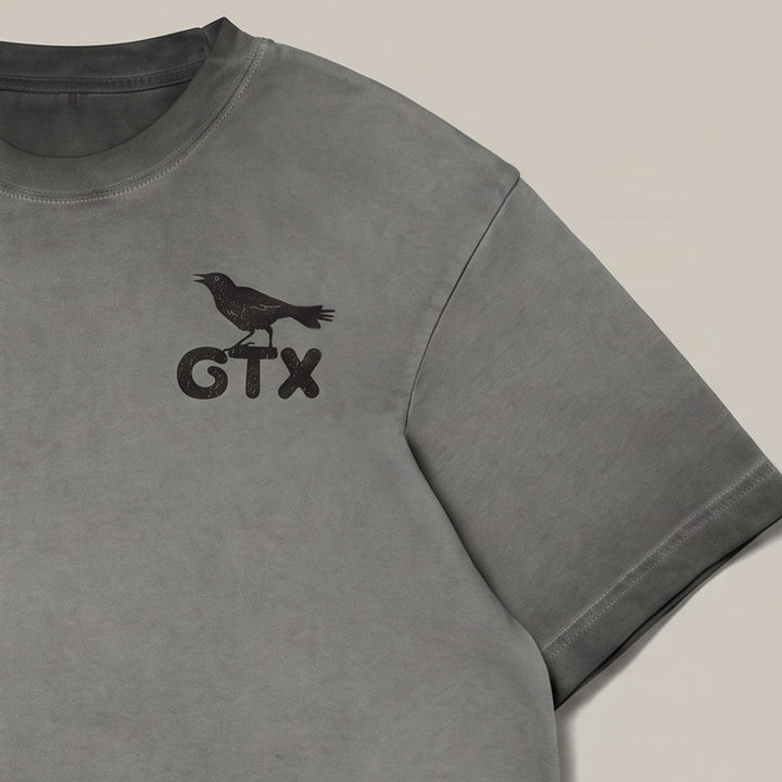 Details of front of Carry-On Georgetown oversized boxy tee in charcoal oil wash featuring small GTX grackle chest print.
