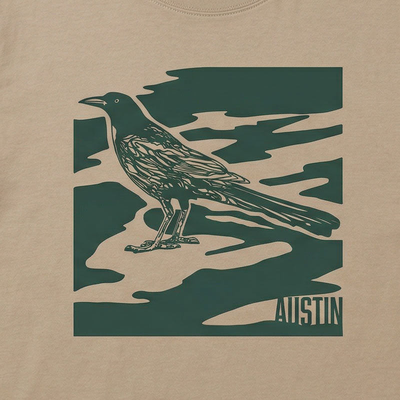 Close-up of garment-dyed camo-inspired Austin graphic with bird illustration