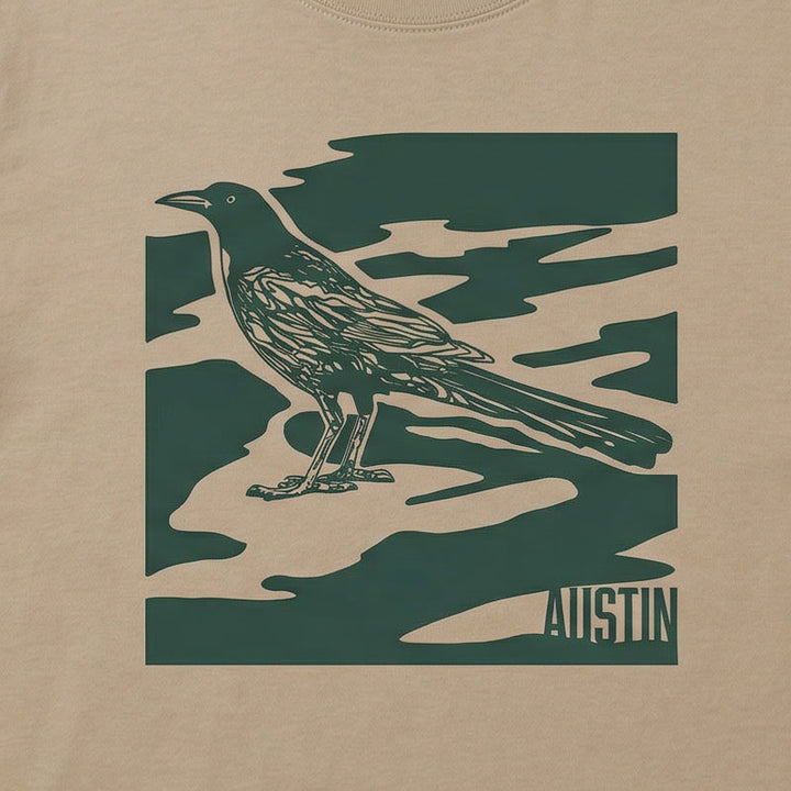 Close-up of garment-dyed camo-inspired Austin graphic with bird illustration