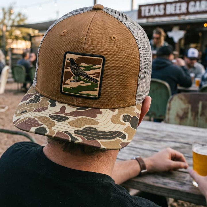 Man wearing City Camo Hat backwards at a Texas Beer Garden