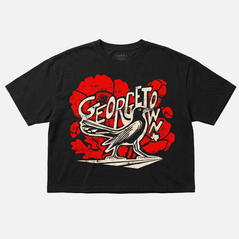 GTX Grackle Strut women’s garment-dyed boxy t-shirt in vintage black with bold grackle and red poppy graphic and relaxed mid-length fit