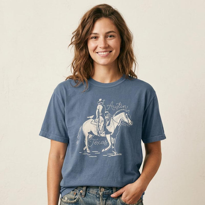 Woman wearing a Denim unisex t-shirt with Austin Texas western inspired print
