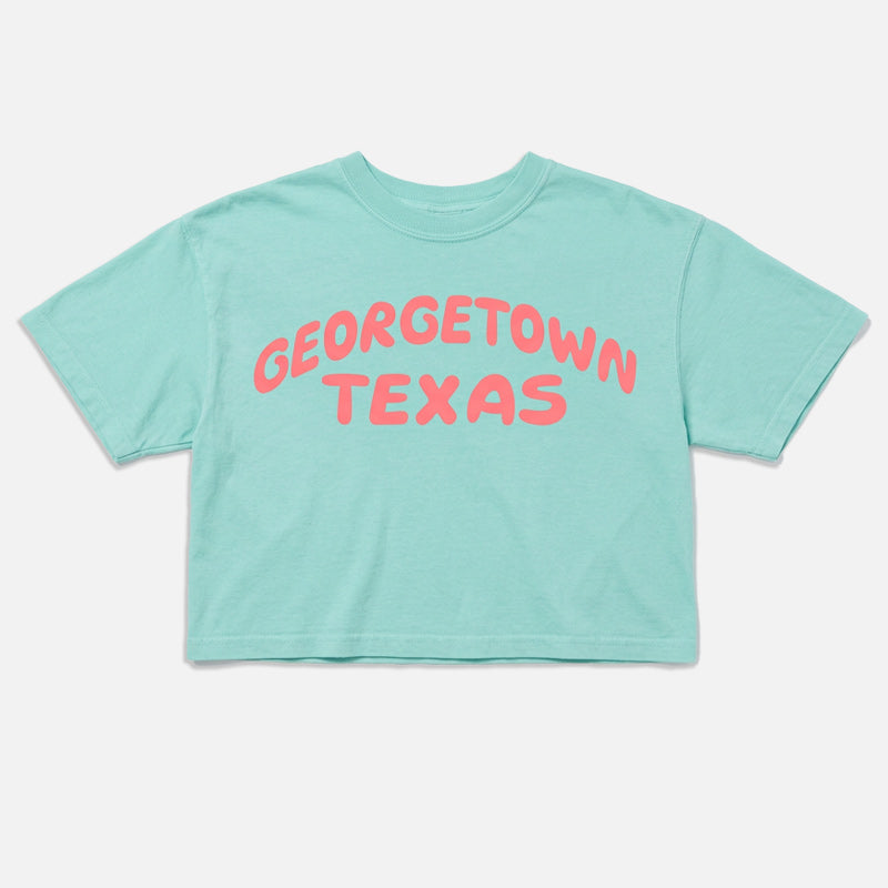 Georgetown Texas women’s boxy t-shirt in Chalky Mint with coral pop graphic flat lay
