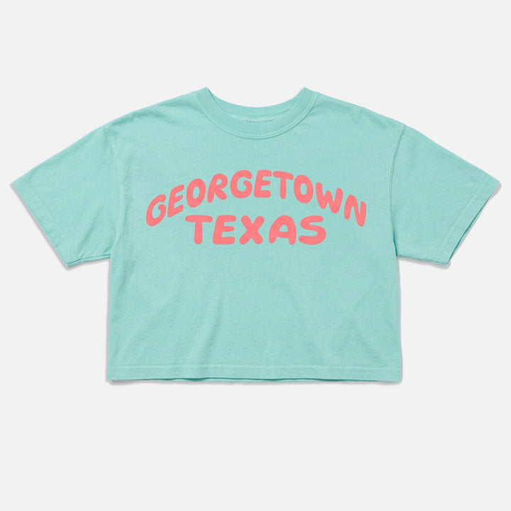 Georgetown Texas women’s boxy t-shirt in Chalky Mint with coral pop graphic flat lay
