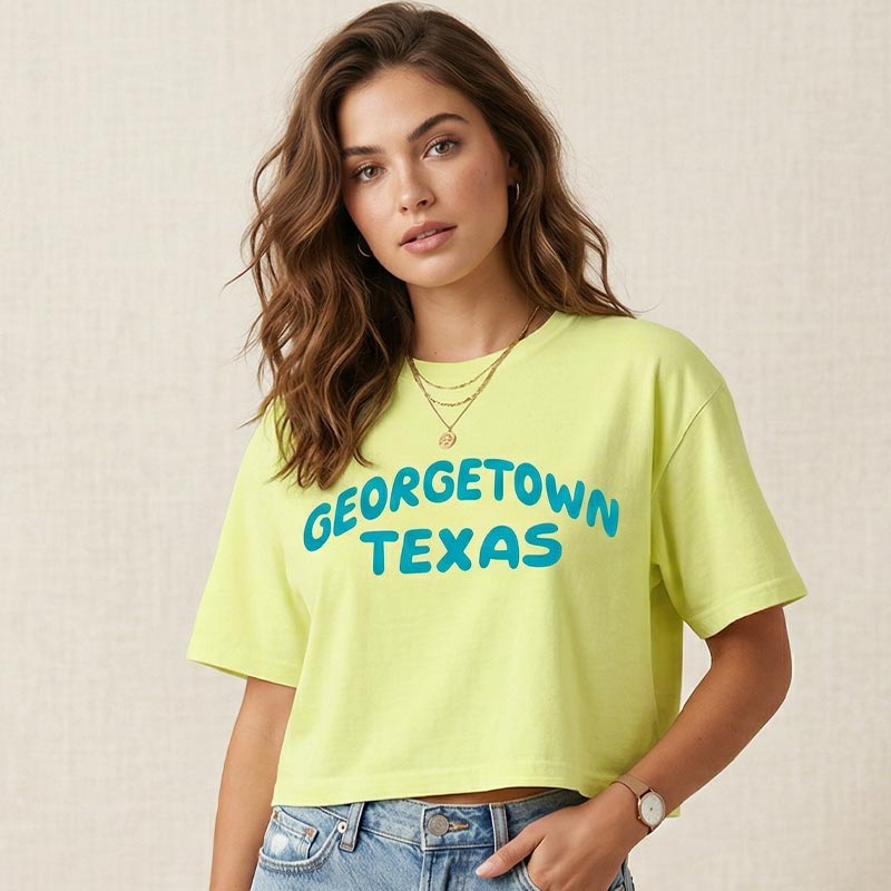 Woman wearing a Georgetown Pop graphic tee in Neon Lemon with blue Georgetown Texas lettering