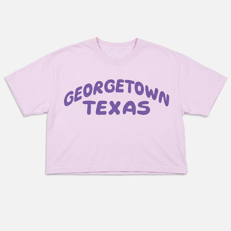 Orchid women’s boxy t-shirt with purple Georgetown Texas retro style graphic flat lay